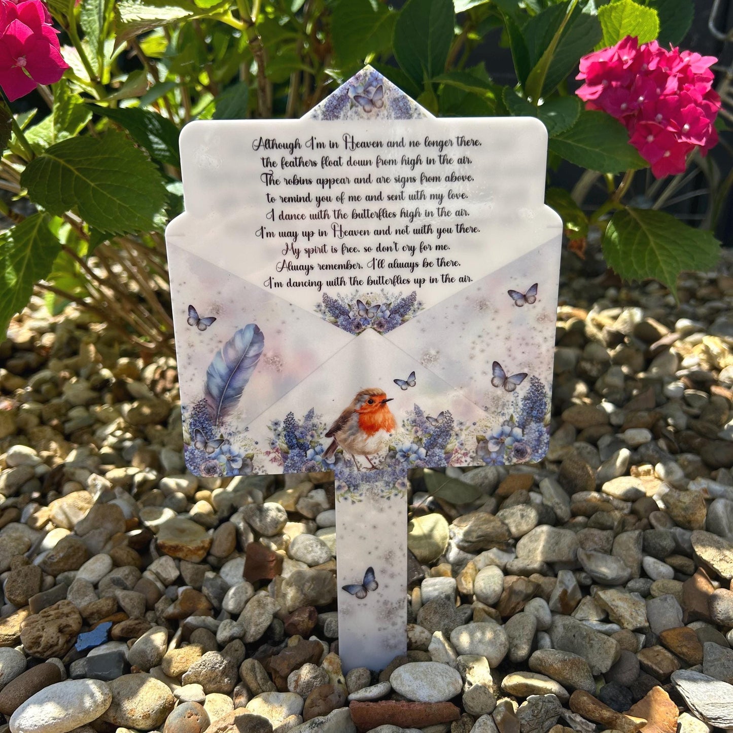 Letter to heaven grave marker shown in a garden setting