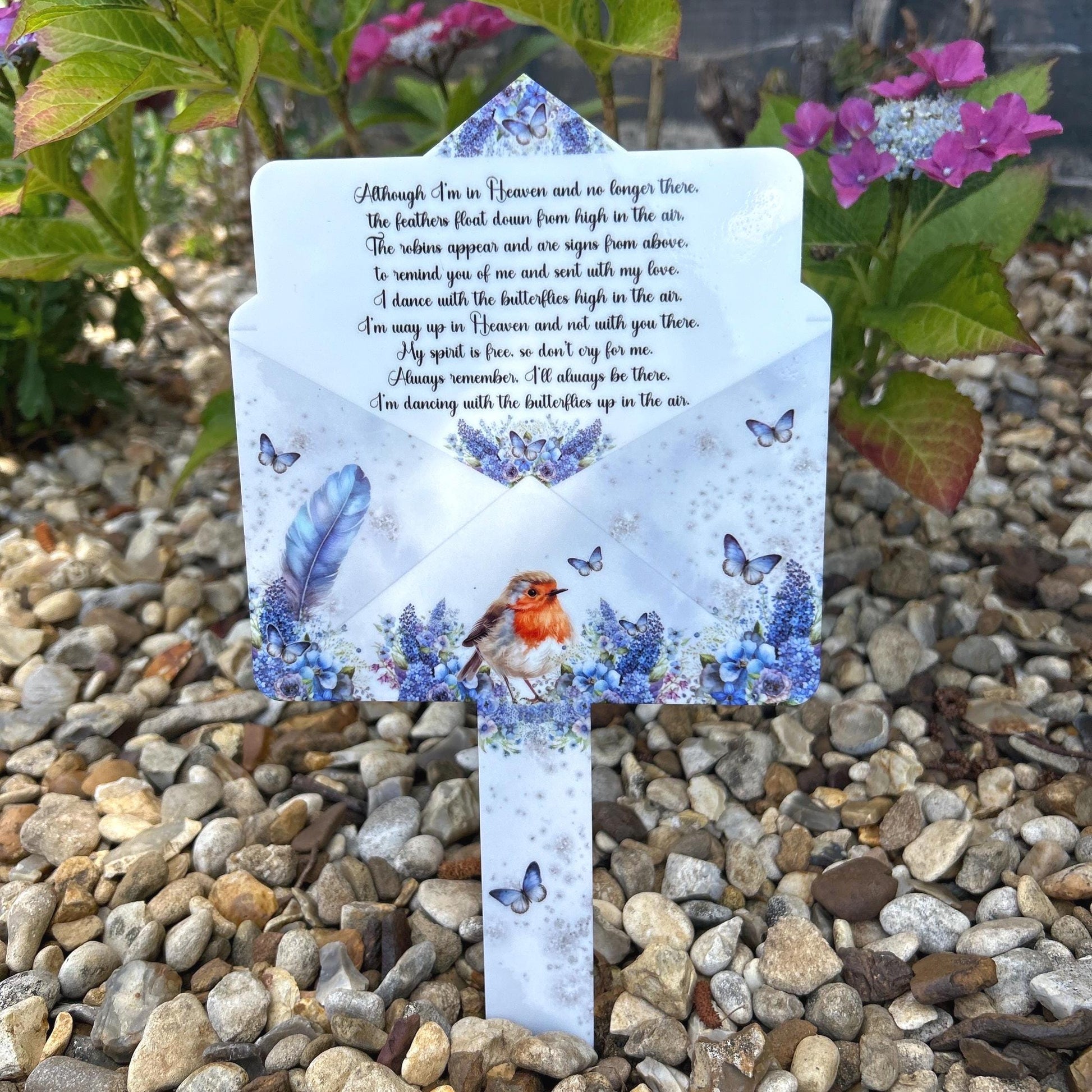 Robin memorial marker with blue feather design at a graveside