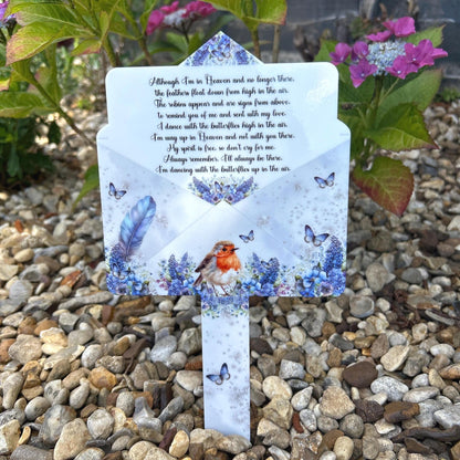 Robin memorial marker with blue feather design at a graveside
