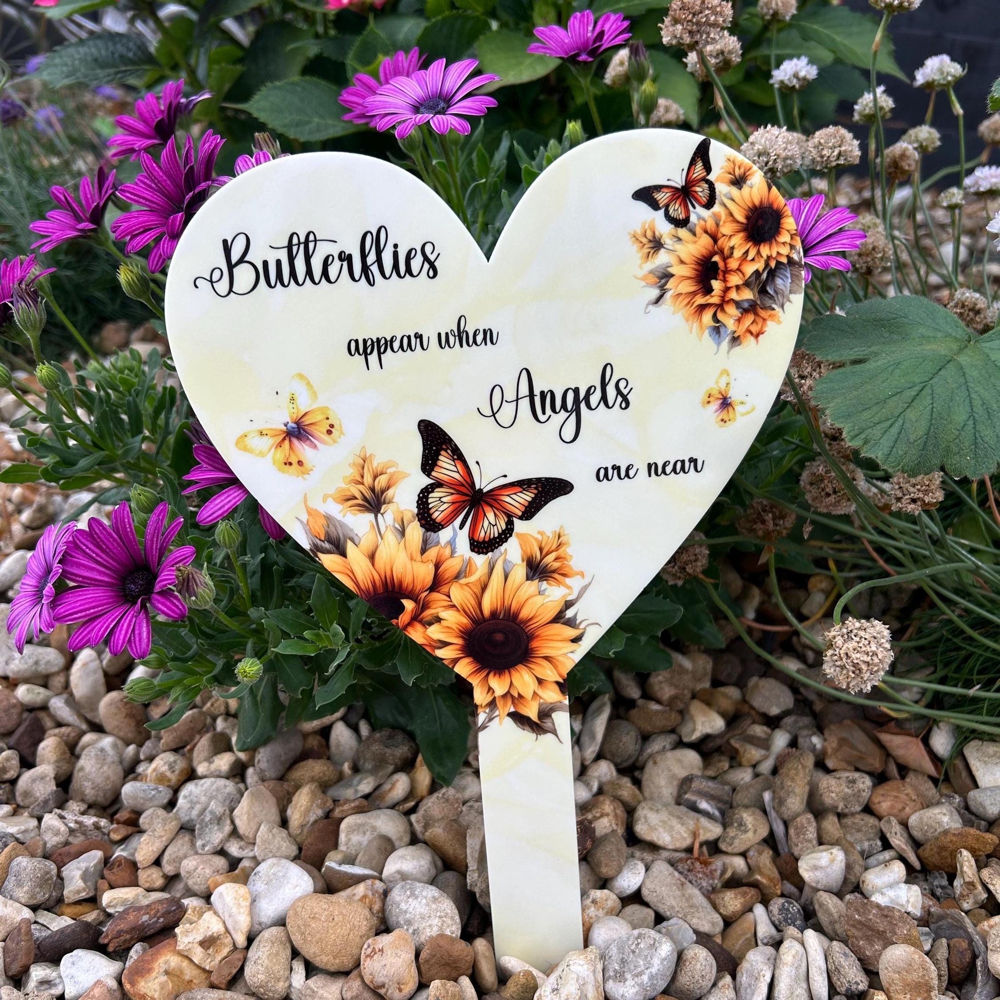 Yellow butterfly heart grave marker placed at a graveside