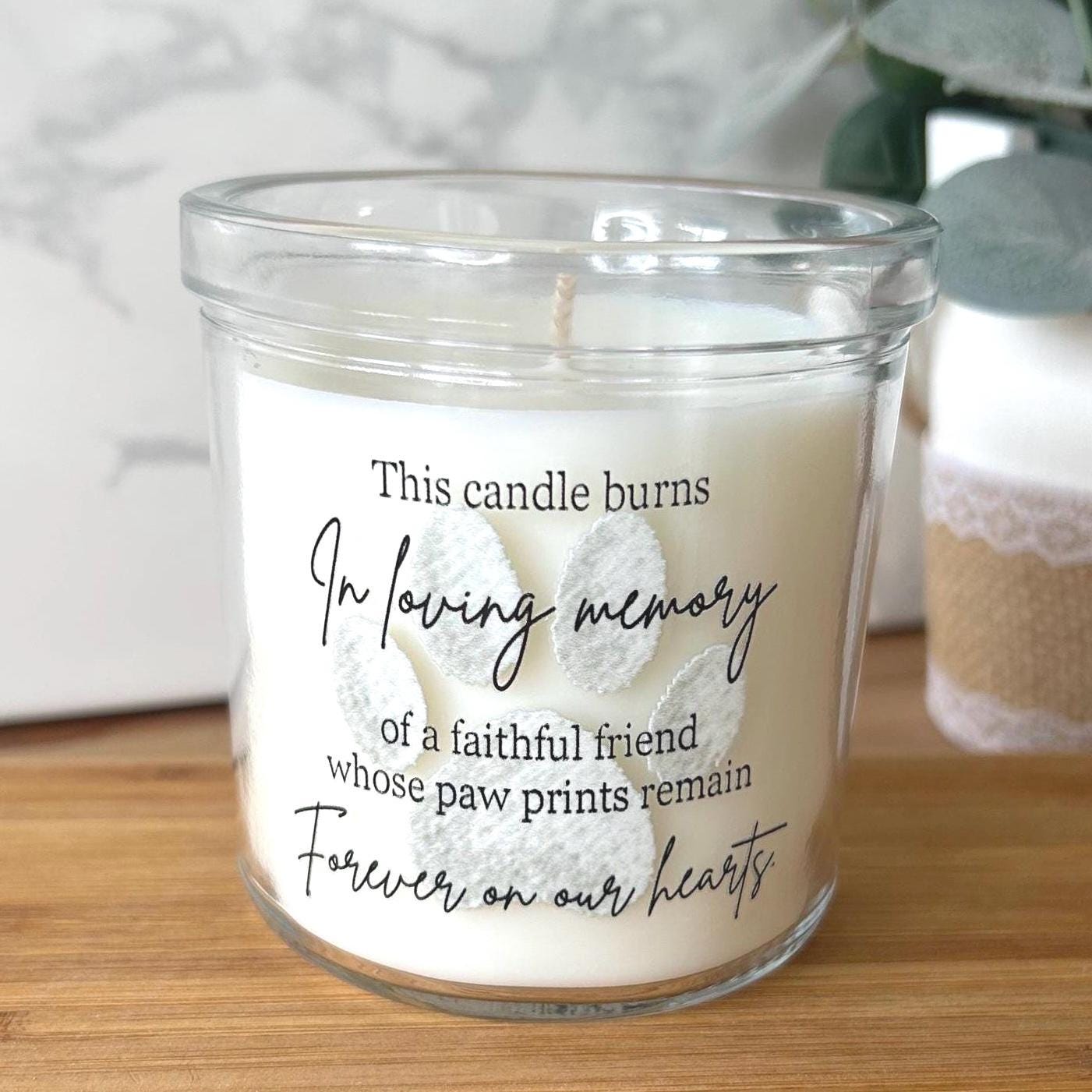 Pet memorial candle with paw print design and printed inscription