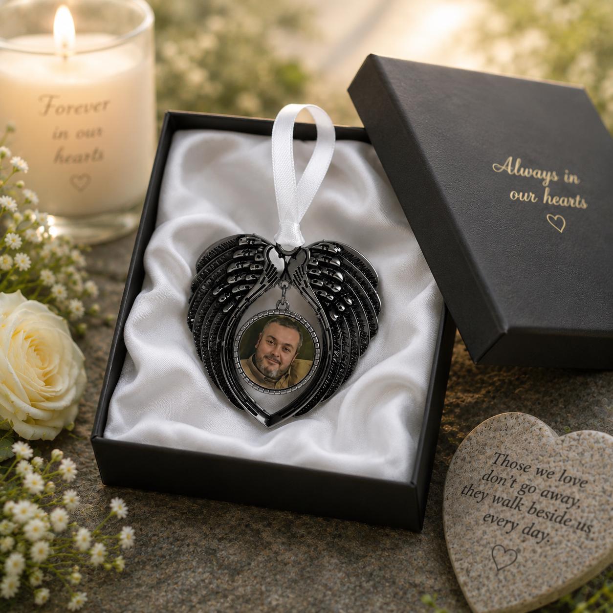 Angel wings memorial charm displayed in a box
