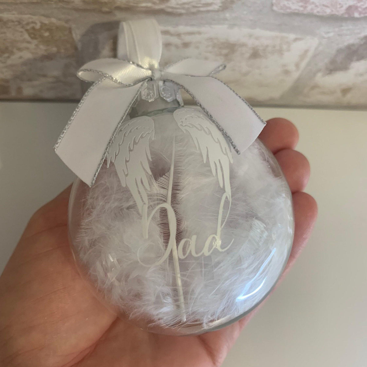 Angel wings memorial bauble filled with white feathers