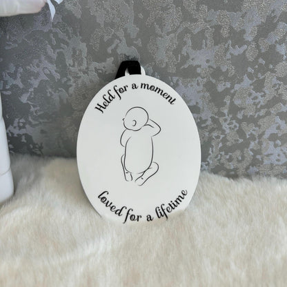 Oval baby loss remembrance decoration with minimalist baby outline and black ribbon