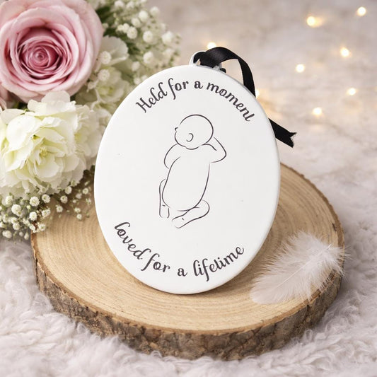 Oval baby loss memorial hanging decoration with infant outline and Held for a Moment quote