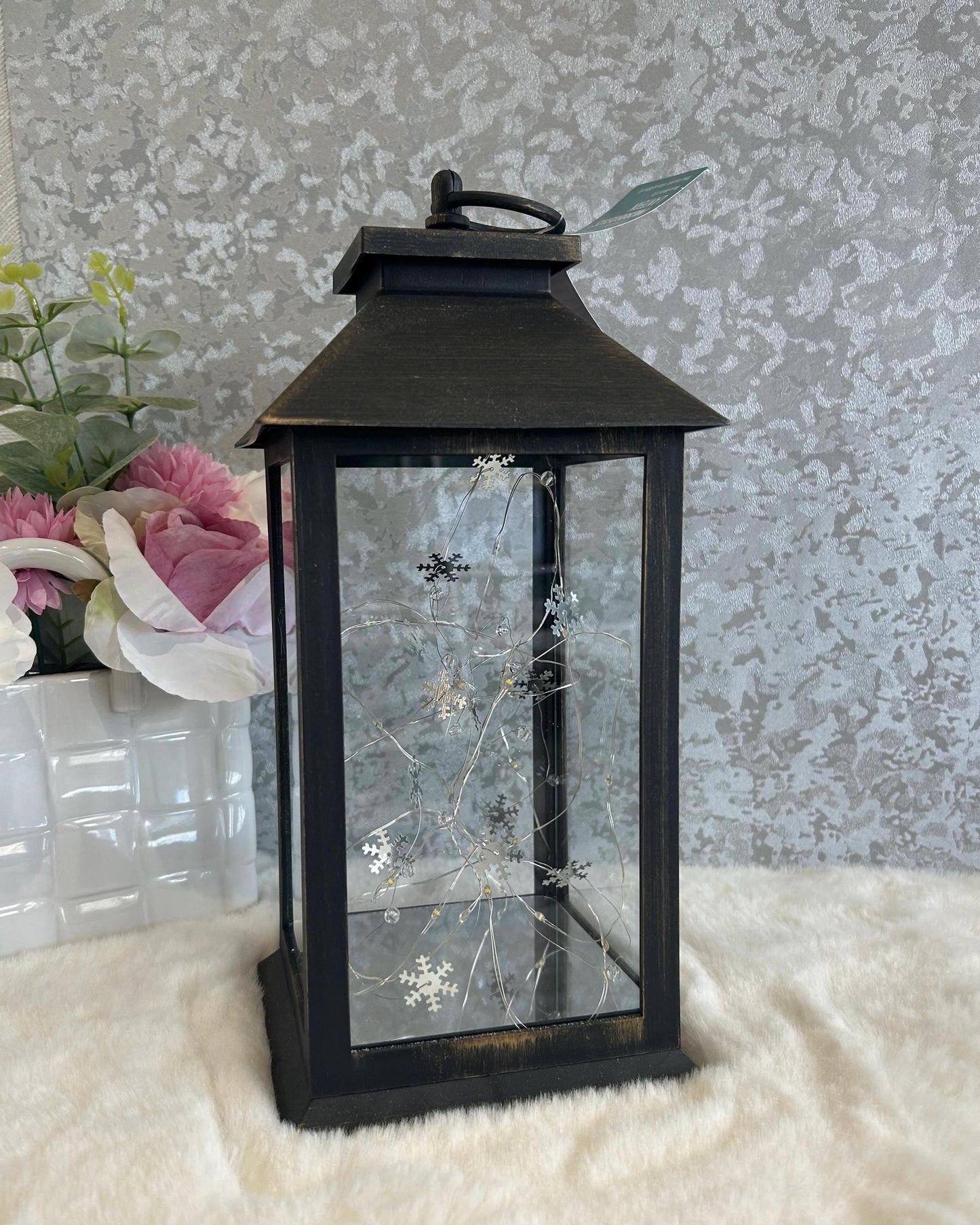 Side view of black and copper large memorial lantern with LED star lights