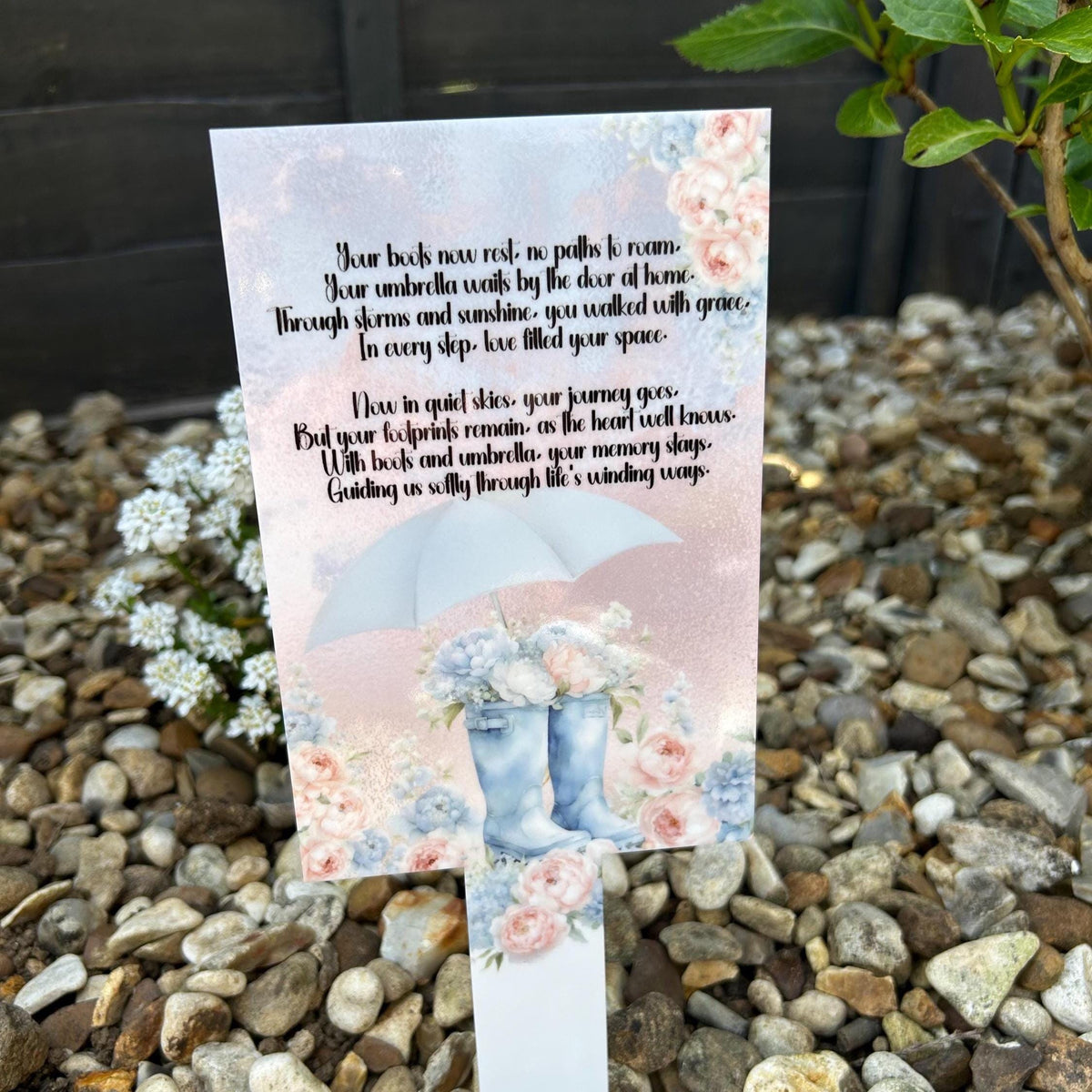 Boots and umbrella grave marker with pink and blue floral memorial design