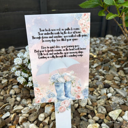 Boots and umbrella grave marker with pink and blue floral memorial design