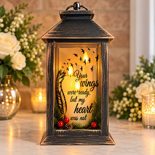 Personalised Christmas memorial lantern with wreath and decorative bow displayed in a warm remembrance setting