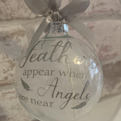 Christmas remembrance bauble with white angel feathers