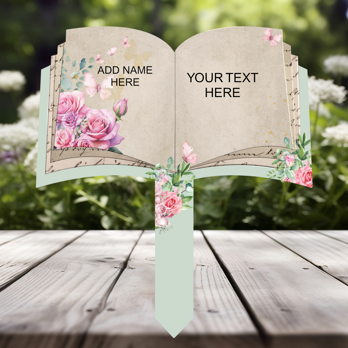 Personalised open book memorial grave marker with pink roses and butterflies, showing custom name and own wording option