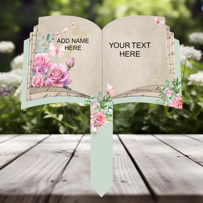 Personalised open book memorial grave marker with pink roses and butterflies, showing custom name and own wording option