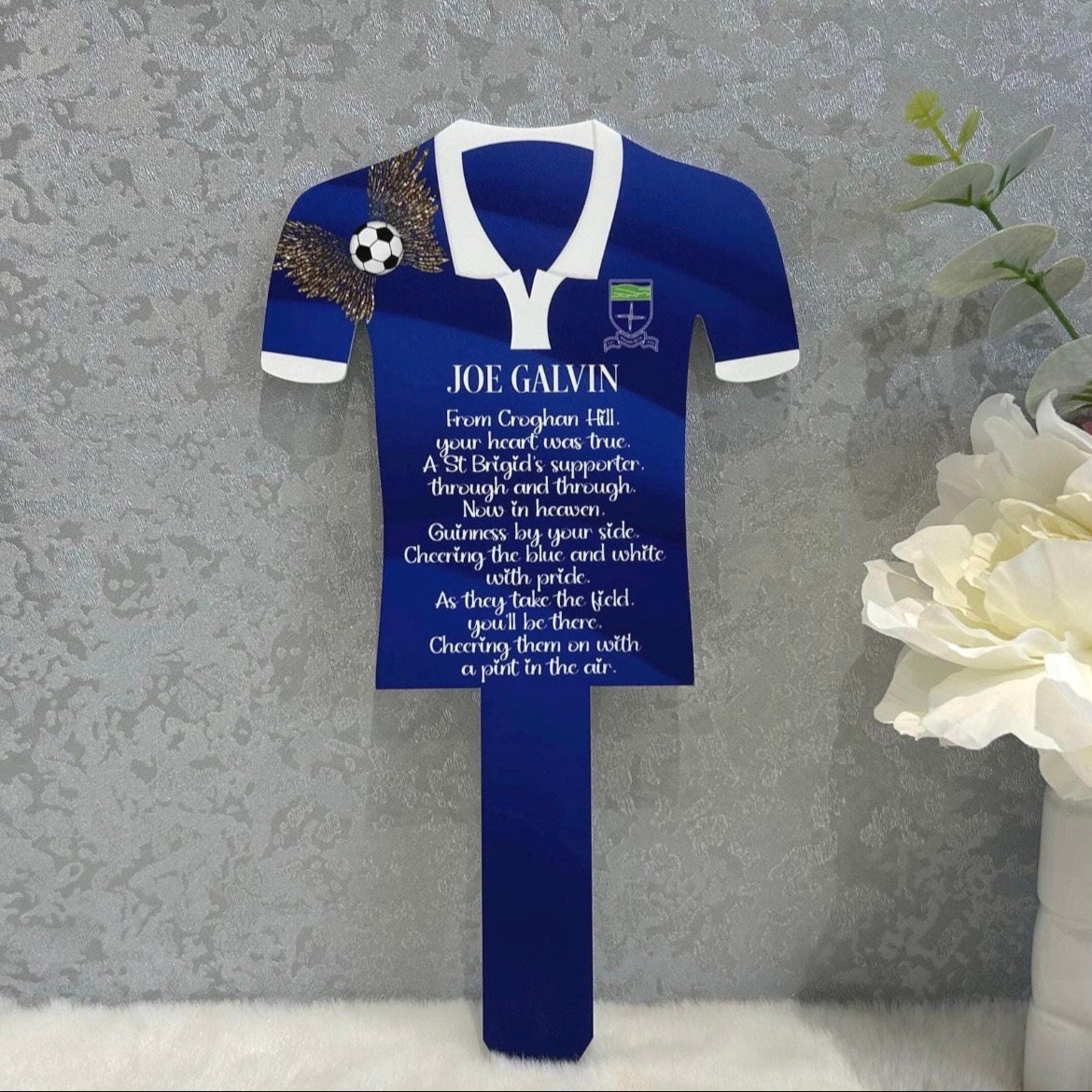 Blue football shirt memorial grave marker personalised for Joe Galvin with St Brigid's supporter tribute