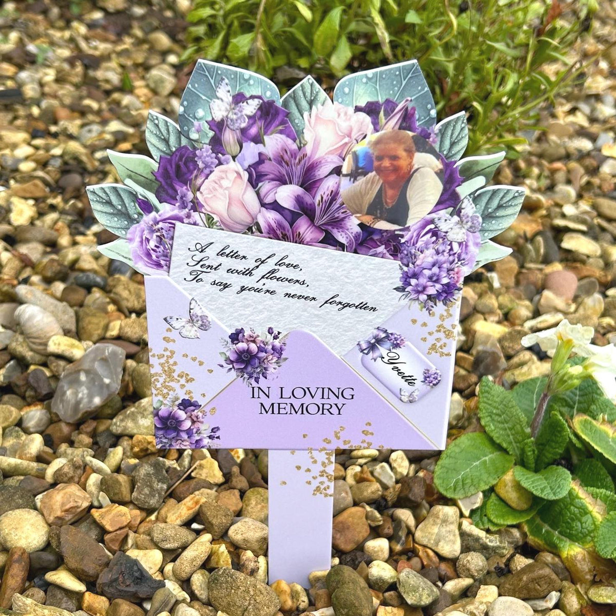 Purple flower bouquet memorial marker for a grave or remembrance garden